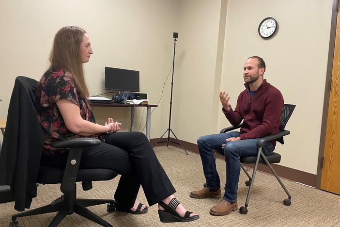 Two clinical counseling psychology students at Brenau University conduct a mock therapy session while seated in an office room.