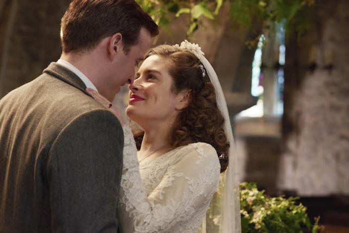 A man and woman embracing at a wedding.