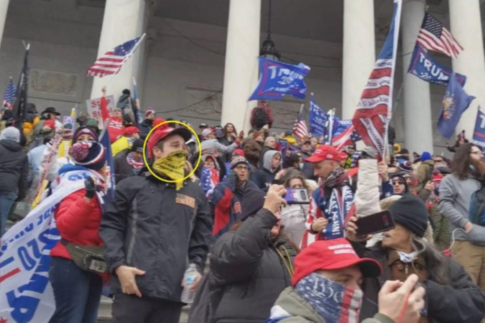 In this photo provided by the FBI, the man in the yellow circle is identified by an agent as Dominic Box on the east stairs of the U.S. Capitol on Jan. 6, 2021.