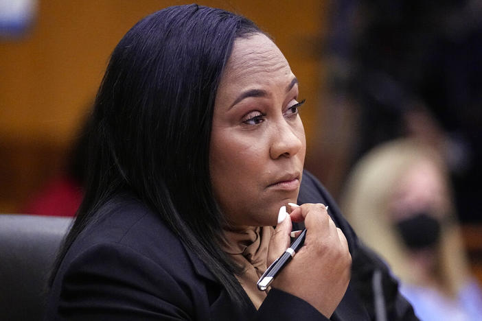 Fulton County District Attorney Fani Willis watches proceedings during a hearing to decide if the final report by a special grand jury looking into possible interference in the 2020 presidential election can be released Tuesday, Jan. 24, 2023, in Atlanta. 
