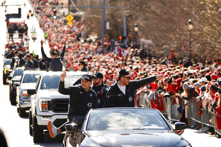 Georgia football players acknowledge the crowd during a parade celebrating the Bulldog's second consecutive NCAA college football national championship, Saturday, Jan. 14, 2023, in Athens, Ga.