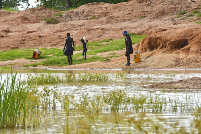 Children in the town of Terekeka, South Sudan, draw water, Oct. 4, 2017, from a stagnant pond that was once infected with Guinea worm when the town was endemic. The Carter Center said Tuesday, Jan. 24, 2023, that only 13 human cases of Guinea worm disease were reported worldwide in 2022.