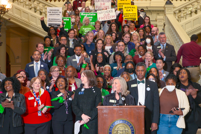 Supporters of SB 15 stand on the steps at the Capitol on Tuesday, Jan. 24