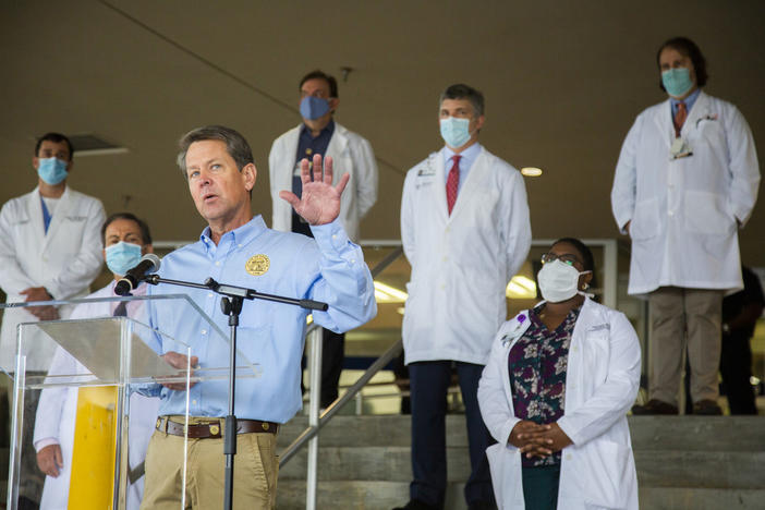 kemp stands with doctors