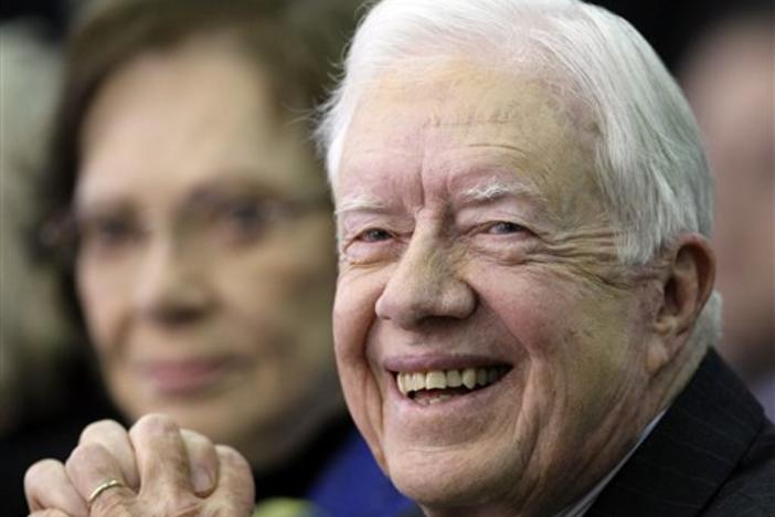 Former U.S. President Jimmy Carter smiles as his wife Rosalynn, rear, looks on while visiting the Cyber University of Korea in Seoul, South Korea, Monday, March 22, 2010. Carter will speech tomorrow about North Korea's nuclear and the Korean peninsula's peace. (AP Photo/ Lee Jin-man)
