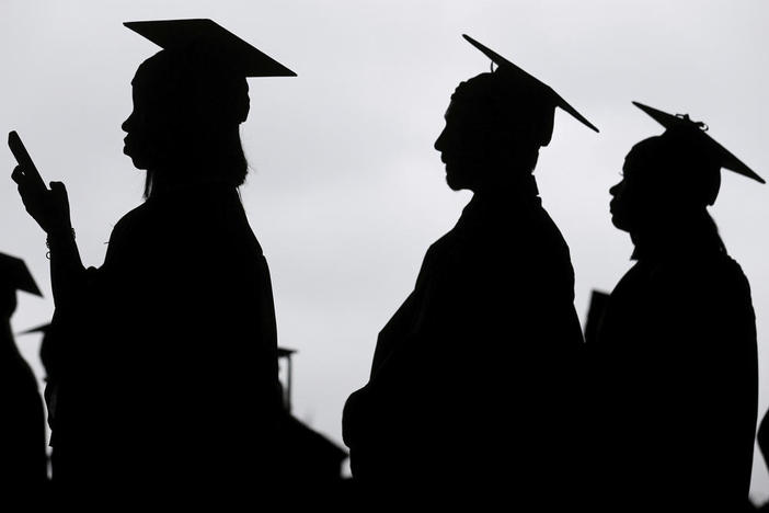 New graduates line up before the start of a community college commencement in East Rutherford, N.J., May 17, 2018.