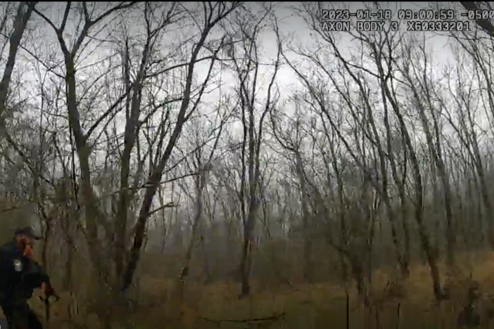 A video still shows two members of law enforcement in the forest near the site of the planned police training facility in Atlanta on Jan. 18, 2023.