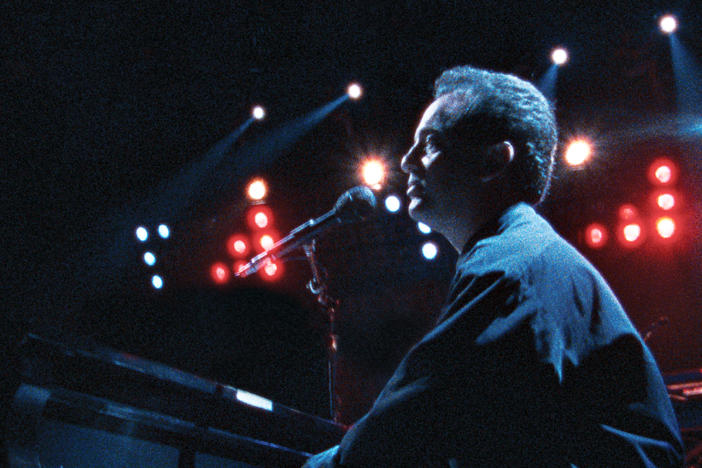 Billy Joel performing at his 1990 concert at Yankee Stadium in The Bronx.