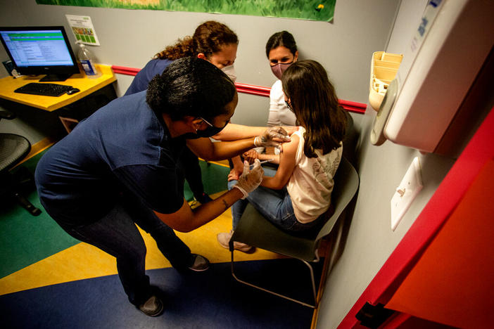 Middle school student Elise Robinson receives a coronavirus vaccination on May 12, 2021, in Decatur, Ga. A bill passed on Wednesday, Feb, 1 2023, by a Georgia Senate committee would ban public schools, local governments or state agencies from requiring people to get the COVID-19 vaccine before they could attend school or receive government services.