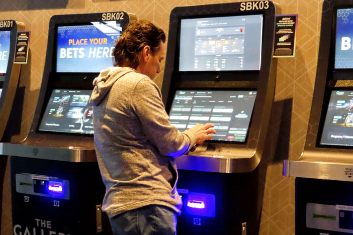 A man checks the odds on a sports betting terminal at the Ocean Casino Resort in Atlantic City, N.J., on Feb. 6, 2023. Georgia lawmakers are considering bills that could legalizing betting on sports and horse racing in the state. A Senate committee on Tuesday, Feb. 14, 2023, held a hearing on a bill that would explicitly include horse racing among sports that could be gambled on. (AP Photo/Wayne Parry, File)