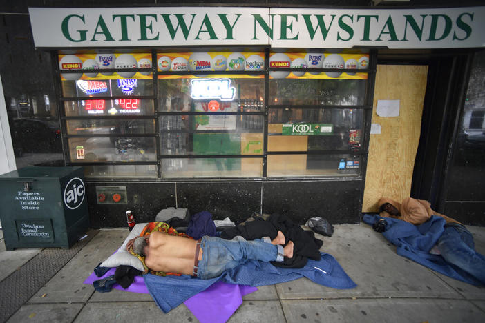 Homeless men sleep on Marietta Street in Atlanta, Friday, June 5, 2020. On Monday, Feb. 13, 2023, a Georgia Senate committee passed a bill that would say cities and counties could not stop enforcing bans on public camping or sleeping.