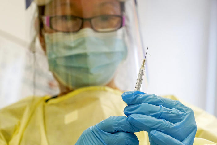 A physician assistant prepares a syringe with the Mpox vaccine for a patient at a vaccination clinic in New York on Friday, Aug. 19, 2022.