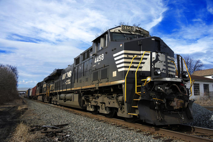 A Norfolk Southern freight train passes passes through East Palestine, Ohio, on Thursday, Feb. 9, 2023. Norfolk Southern on Wednesday, Feb. 23, 2023, became the third major freight railroad to offer some of its employees paid sick time, announcing a deal with one of its unions in response to workers' quality-of life complaints that arose during contract negotiations. 