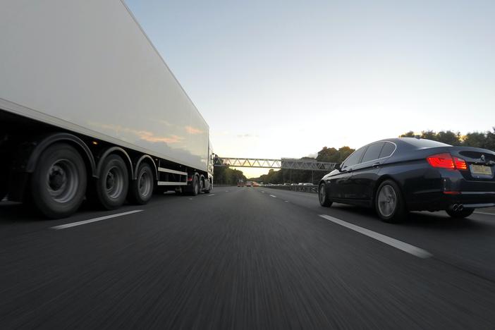 Highway with truck and car in opposite lanes