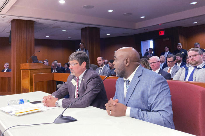 Logging company owner Toby McDowell of Locust Grove, Georgia, right, testifies in favor of higher weight limits on roads and bridges on Thursday, Feb. 9, 2023 at the state capitol in Atlanta. An industry-backed bill would raise truck weight limits in Georgia to 90,000 pounds.