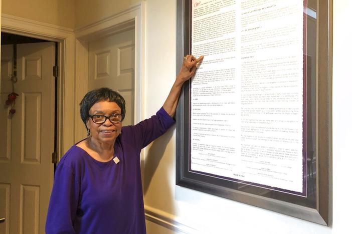 In this March 4, 2020 photo, Roslyn Pope poses with a framed copy of "An Appeal for Human Rights" in her home in Atlanta. Roslyn Pope, a college professor and musician who wrote “An Appeal for Human Rights,” laying out the reasons for the Atlanta Student Movement against systemic racism in 1960, has died. She was 84. Pope died on Jan. 18 in Arlington, Texas, where she moved from Atlanta to be with her daughters after her health began to fail in 2021, according to her family's obituary.