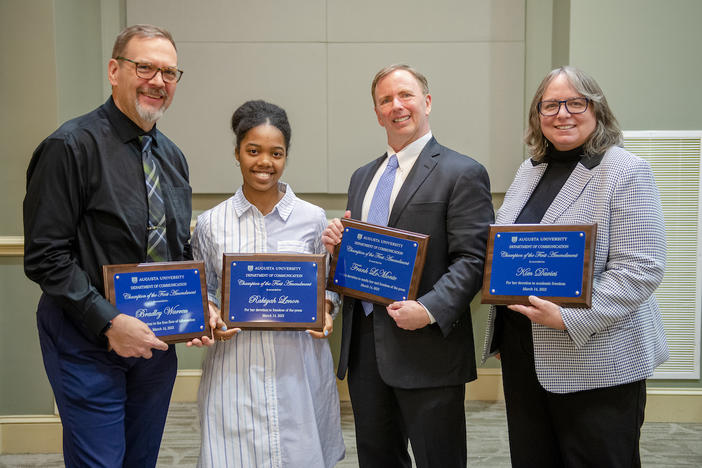 August University's Library Dean Bradley Warren, student newspaper editor Rakiyah Lenon, guest speaker and attorney Frank LoMonte and Pamplin College Dean Kim Davies receive their Champion of the First Amendment Awards on March 14, 2023. 