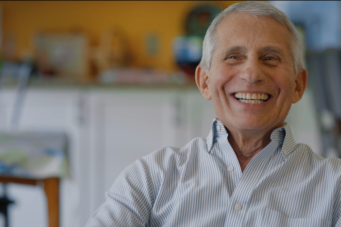 Dr. Anthony Fauci laughs while being interviewed in his home.