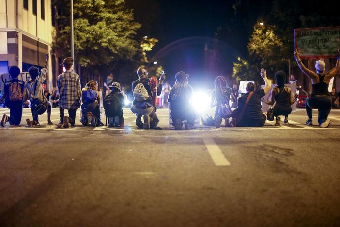  Black Lives Matter protesters sit on Peachtree Street during a protest in downtown Atlanta, Saturday, Sept. 24, 2016, in response to the police shooting deaths of Terence Crutcher in Tulsa, Okla. and Keith Lamont Scott in Charlotte, N.C.