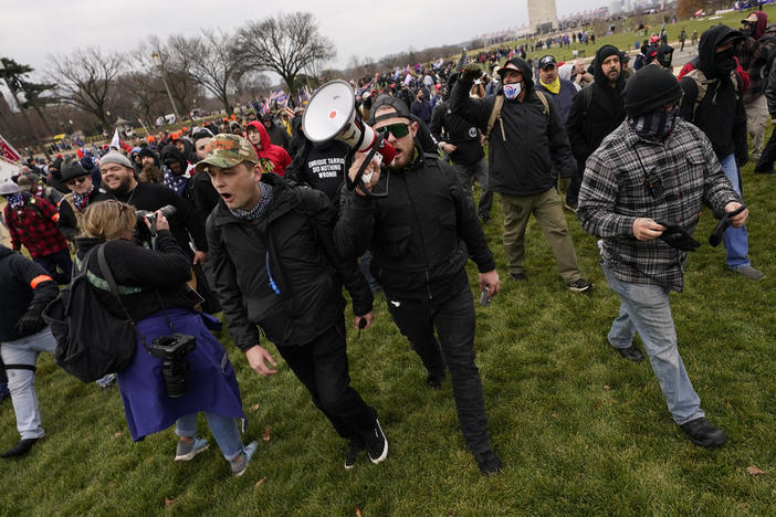 In this Wednesday, Jan. 6, 2021 file photo Ethan Nordean, with backward baseball hat and bullhorn, leads members of the far-right group Proud Boys in marching before the riot at the U.S. Capitol. Nordean, 30, of Auburn, Washington, has described himself as the sergeant-at-arms of the Seattle chapter of the Proud Boys. The Justice Department has charged him in U.S. District Court in Washington, D.C., with obstructing an official proceeding, aiding and abetting others who damag