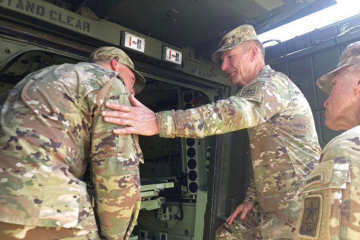 Army Chief of Staff Gen. James McConville, middle, gets a closeup look at one of the Army's new armored multi-purpose vehicles at Fort Stewart, Ga., on Tuesday, March 7, 2023.