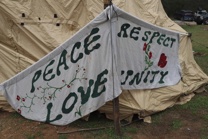 A tent is set up at the entrance to the South River Forest in DeKalb County, Ga., near the site of a planned police training center on March 9, 2023. Activists have been protesting the center's planned construction for more than a year, derisively calling it "Cop City."