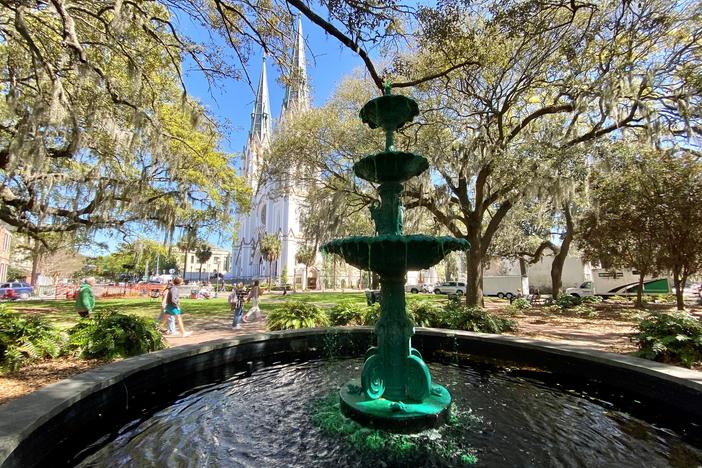 The Savannah St. Patrick's Day parade will pass by several downtown squares, including Lafayette Square, where the fountain's water has been dyed green. The parade will begin after morning mass at the Cathedral Basilica of St. John the Baptist, seen here in the background.