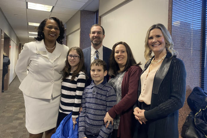 The Genauers, state Rep. Debra Bazemore D-South Fulton and state Sen. Elena Parent (D-Dekalb) smile on Monday, March 13, 2023, after the Small Business Development House committee unanimously cleared Senate Bill 55.