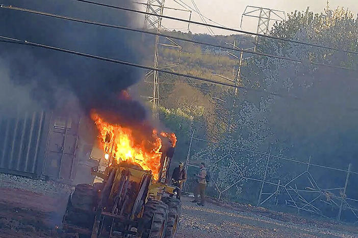 This image provided by the Atlanta Police Department shows construction equipment set on fire Saturday, March 4, 2023 by a group protesting the planned public safety training center, according to police.
