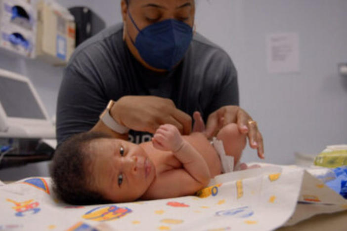 A doctor doing a check-up on an infant.