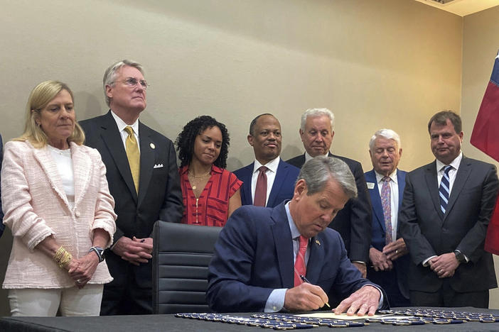 Georgia Gov. Brian Kemp signs into law a bill aimed at making public schools safer during a ceremony in Savannah, Ga., on Thursday, April 13, 2023. The measure requires Georgia schools to hold annual drills on responding to campus shooters. The governor also signed new laws intended to improve literacy among students in kindergarten through third grade.