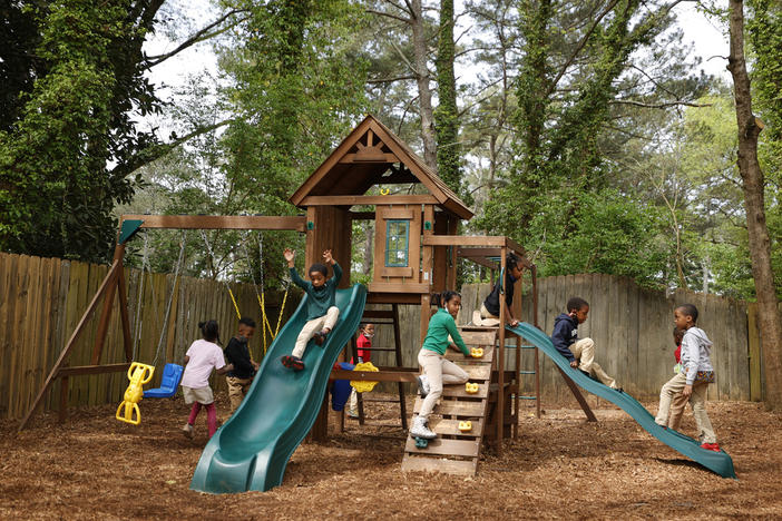 Students play on the playground at the Kilombo Academic and Cultural Institute, Tuesday, March 28, 2023, in Decatur, Ga. 