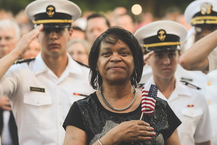 A woman with a flag stands.