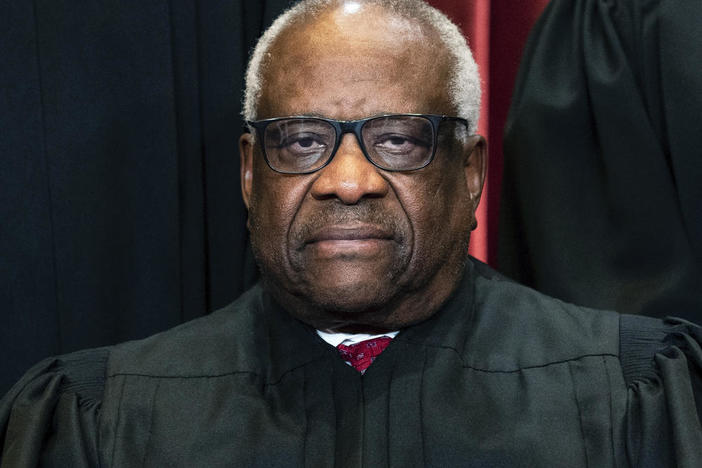 Associate Justice Clarence Thomas sits during a group photo at the Supreme Court in Washington, Friday, April 23, 2021.