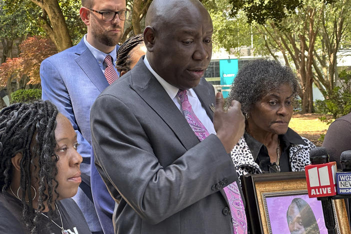 Prominent civil rights attorney Ben Crump speaks at a news conference on Wednesday, May 24, 2023, in Decatur, Ga., announcing a wrongful death lawsuit filed by the family of a Georgia woman who died after she fell out of a moving patrol car in July 2022, following her arrest. Crump was joined in front of the old courthouse in Decatur, by Brianna Grier's sister Lottie Grier, left, and mother Mary Grier, right. 