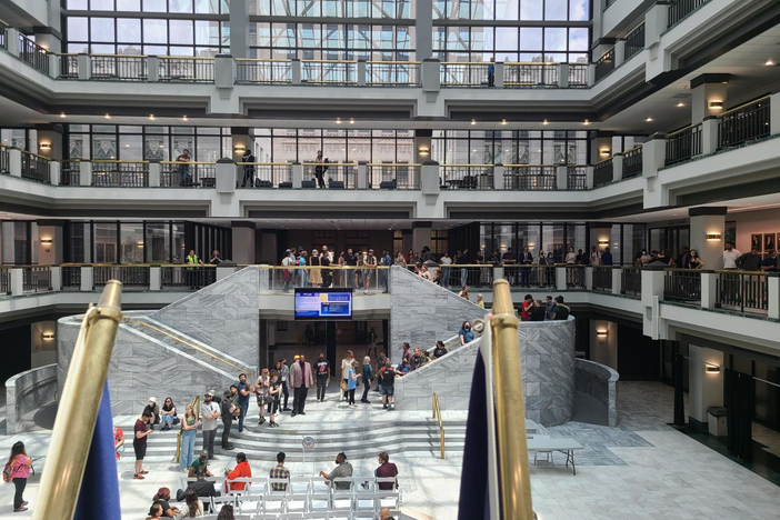 Hundreds of people lined up at City Hall to sign up to speak out against the police training center at a city council meeting May 15, 2023.