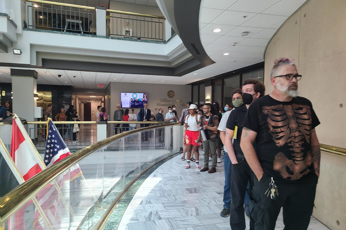 Hundreds of people lined up at City Hall to sign up to speak out against the police training center at a city council meeting May 15, 2023.