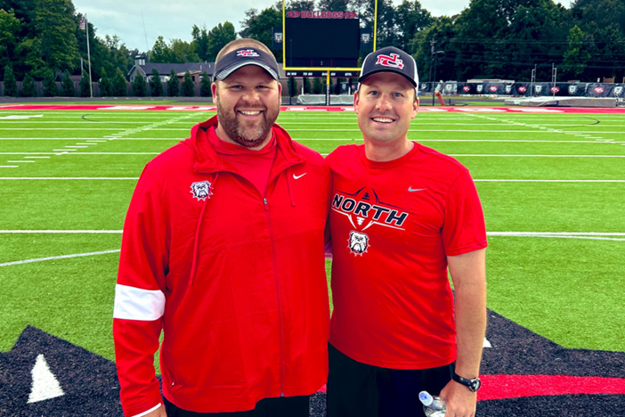 New North Gwinnett High School football coach Eric Godfree (right) and offensive line coach Nick Johnson (left) during the Bulldogs spring practice in May.