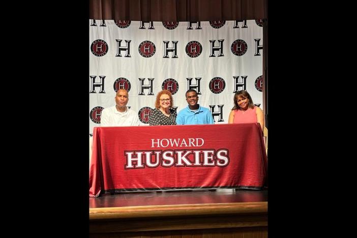 Chase, center, is pictured with his parents, Charles and Felisha Kitchens, and Bibb County school board member Lisa Garrett.