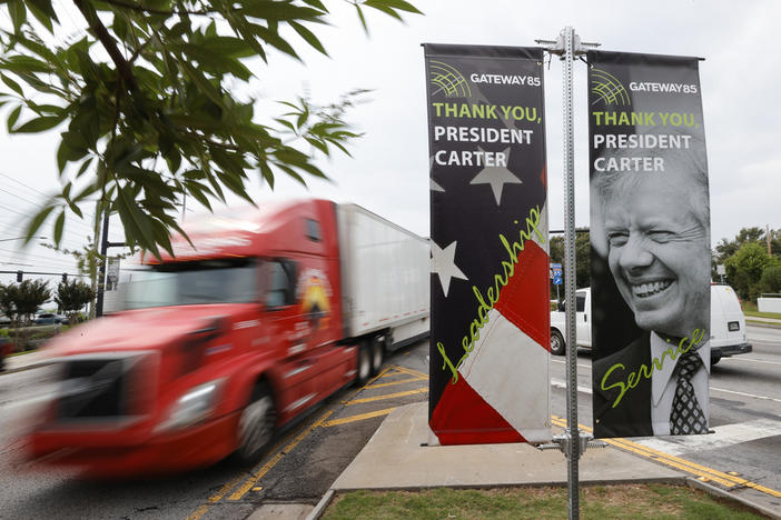 Motorists pass a sign dedicated to former President Jimmy Carter along Jimmy Carter Blvd. on Tuesday, May 23, 2023, in Norcross, Ga.