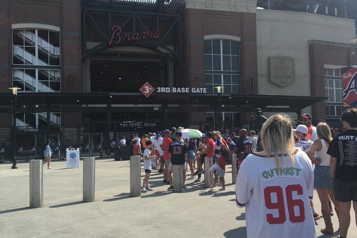 Tosha Murphy of Douglasville waits in line for an OutKast bobblehead.