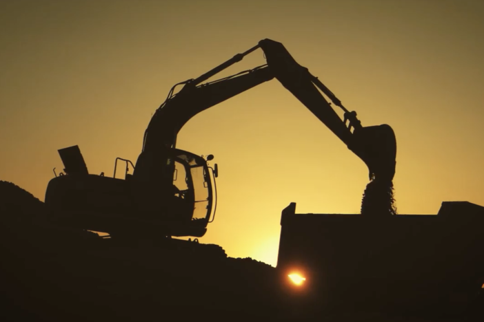 Silhouette of heavy construction equipment.