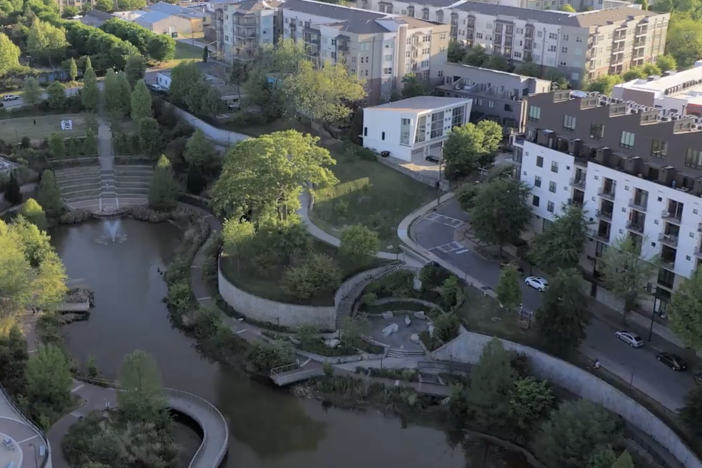 Bird's-eye view of a developing city with waterways and housing