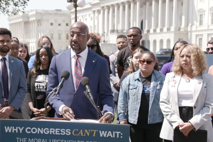  Sen. Raphael Warnock, left and Rep. Lucy McBath, right, urge Congress to take up new gun regulations.