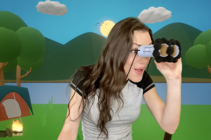 Host, Ashlyn Süpper, looks through craft binoculars with excitement.