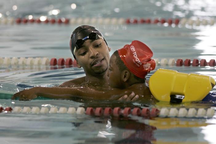 In this Sept. 25, 2007, file photo Olympic swimmer Cullen Jones, left, teaches water safety to Jaquil Wise, 7, at the pool in Newark, N.J., where Jones learned to swim. Jones won a gold medal at the Olympics on the U.S. men's 400 meter relay team at the Beijing Olympics Monday, Aug. 11, 2008.