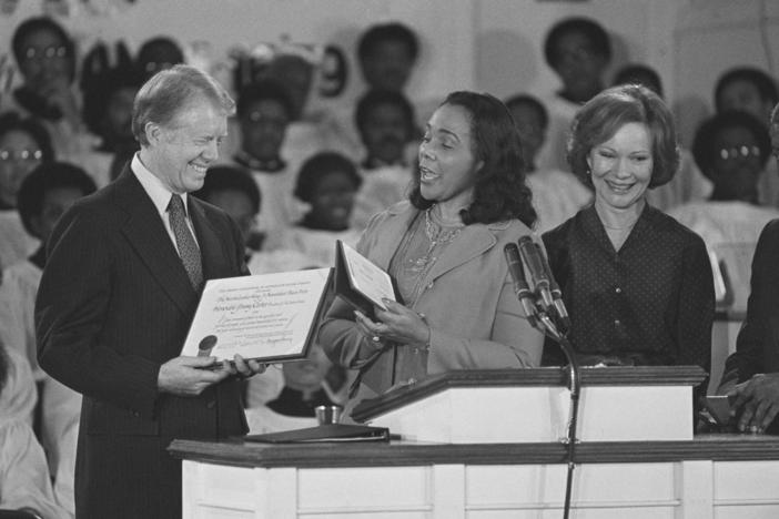 Coretta Scott King, center, widow of Martin Luther King Jr., presents the Martin Luther King Jr. Non-Violent Peace to President Jimmy Carter at the Ebenezer Baptist Church in Atlanta on Jan. 14, 1979. First lady Rosalyn Carter stands with them at the podium. 