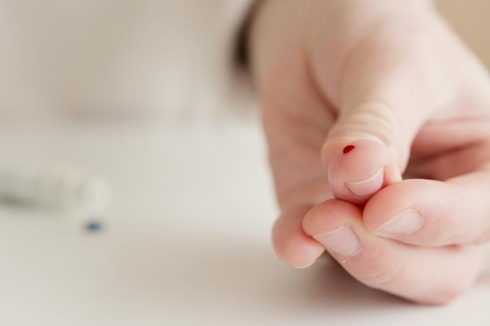 A blood drop on a finger 