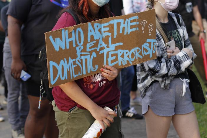 A protester holds a sign outside the Dekalb County Jail in May 2023. 