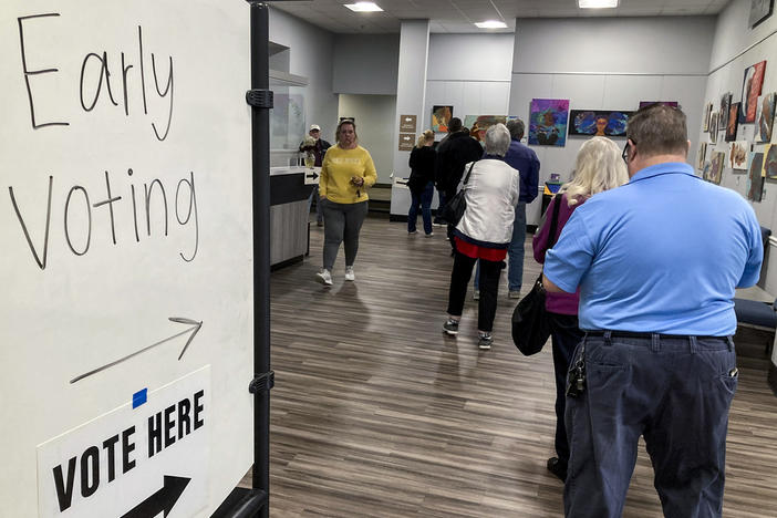 People wait in line to early vote for the U.S. Senate runoff election in Georgia between Sen. Raphael Warnock and challenger Herschel Walker, on Nov. 28, 2022, in Kennesaw, Ga., near Atlanta. After years of criticizing mail voting and trying to ban so-called "ballot harvesting," Republicans are reversing course. They are poised to launch aggressive get-out-the-vote campaigns for 2024 that employ just those strategies.